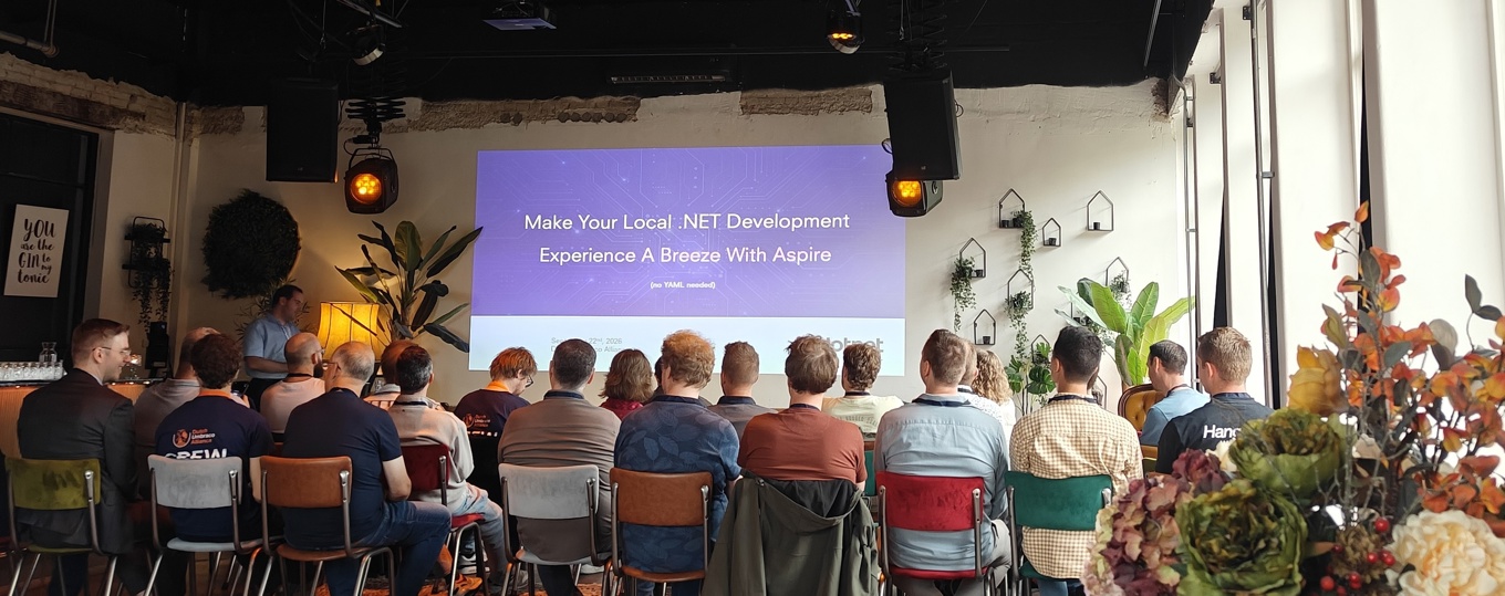 Several individuals in chairs, focused on a screen displaying a presentation